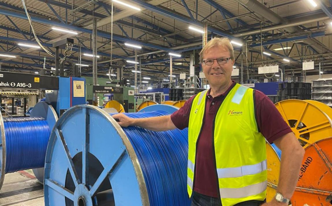Jon Snesrud in Nexans posed in front of a drum containing the blue TQXP heating cable