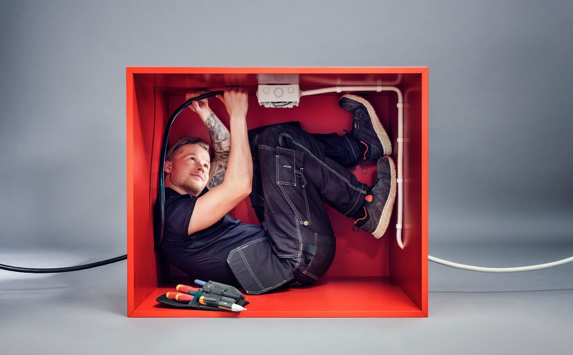 Electrician in a small box that demonstrates the flexibility of TXXP FLEX90